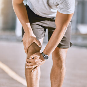 Male holding his knee in pain