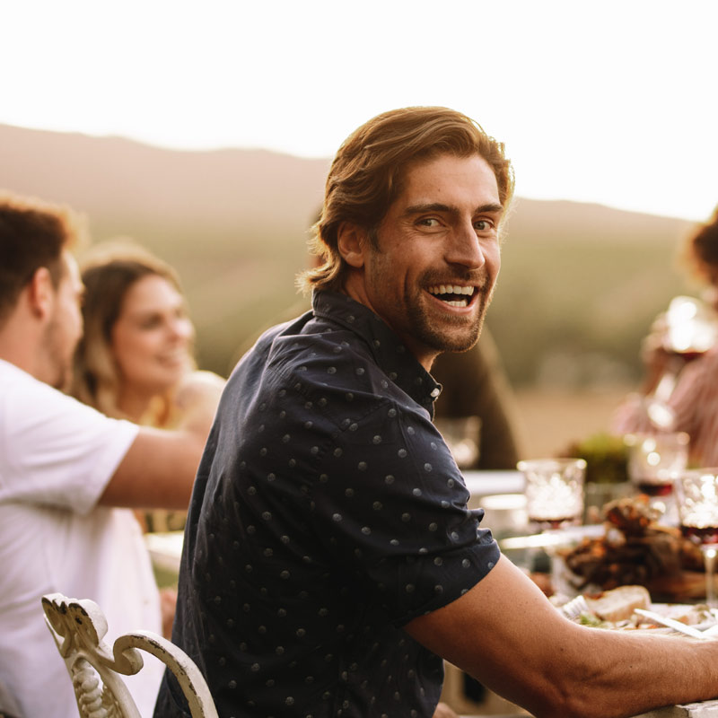 Young guy enjoying at outdoor party with friends