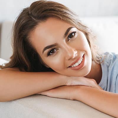 Close up of a smiling young woman relaxing