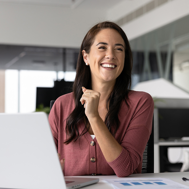 Smiling woman working at a modern office desk. Smiling woman working at a modern office desk.
