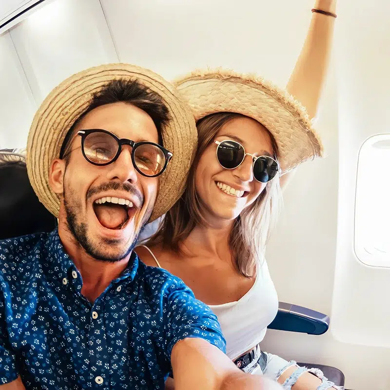 Happy tourist taking selfie inside airplane Happy tourist taking selfie inside airplane